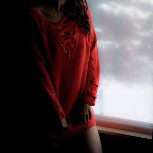 Orange off the shoulder baggy shirt.